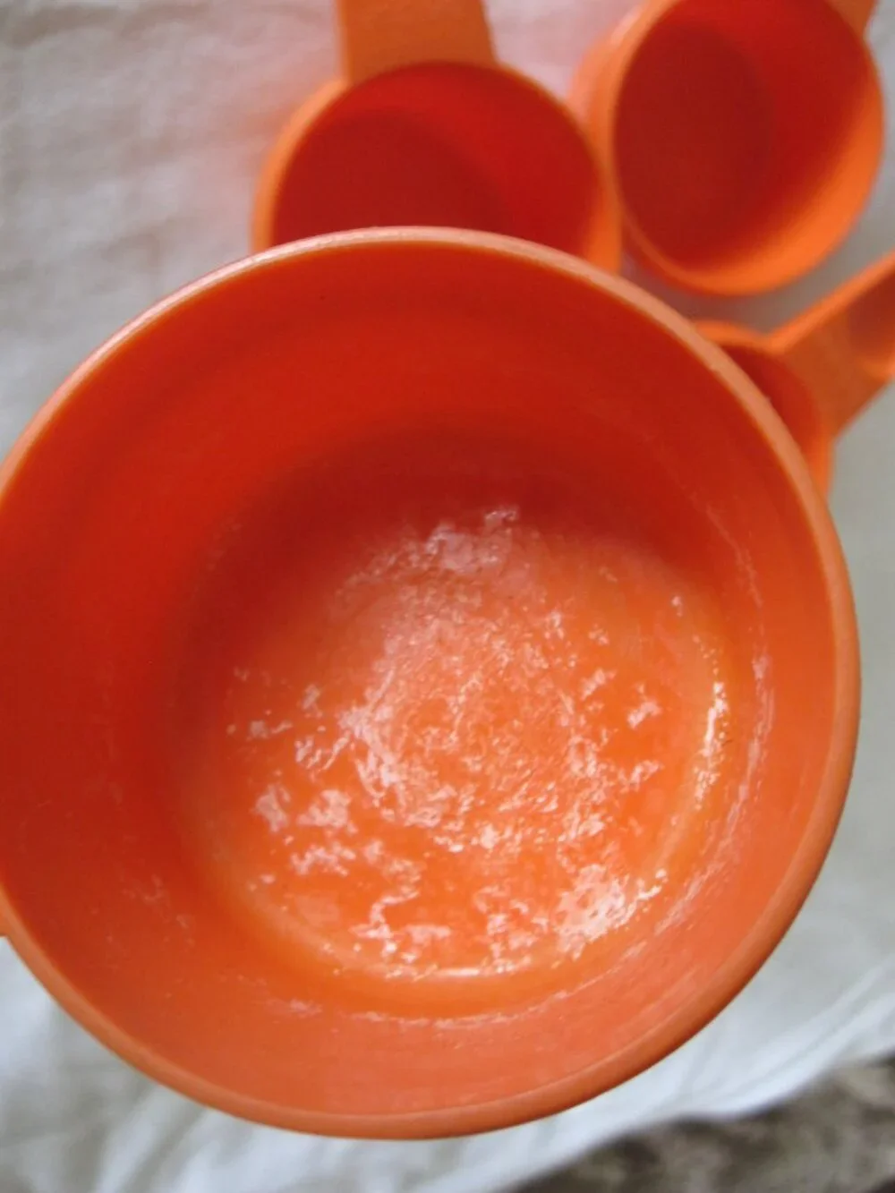 set of (4) vintage Tupperware Measuring Cups - Orange, 1/3, 1/2, 2/3, 3/4